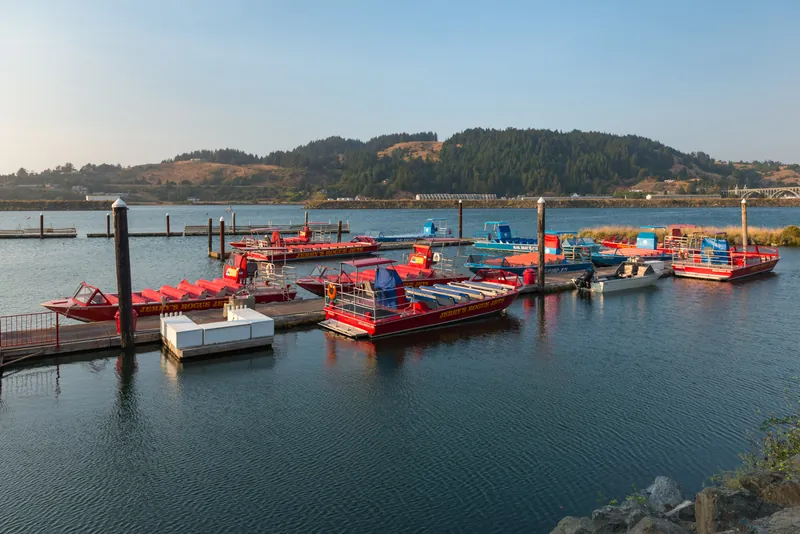 Red jet boats moored at Jerry’s Rogue Jets in Gold Beach Harbor